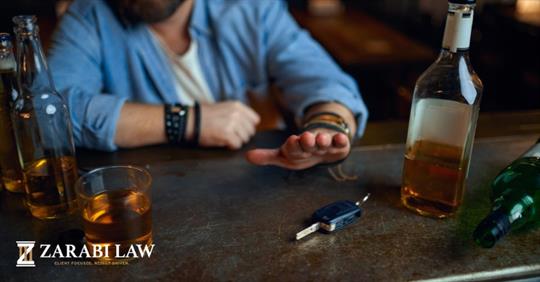 man with liquor and car keys